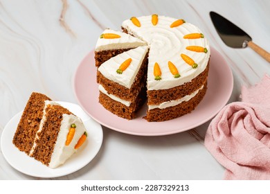 Carrot cake on the cake stand, made with carrots, walnuts, cinnamon, iced with cream cheese. Sweet healthy homemade dessert for kids. - Powered by Shutterstock