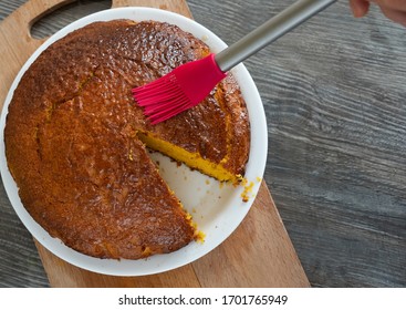 Carrot Cake On A Wooden Board With A Red Brush. View From Above
