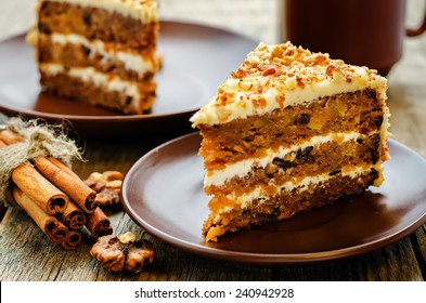 carrot cake with walnuts, prunes and dried apricots on a dark wood background. tinting. selective focus