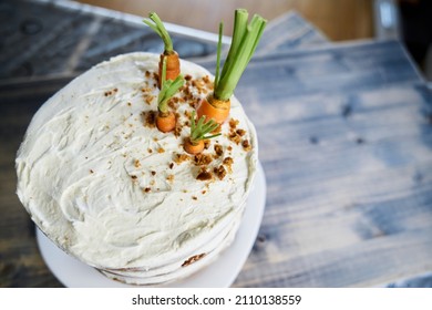 Carrot Cake With White Frosting Garnished With Fresh Carrots. View From Above