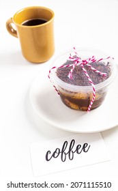 Carrot And Chocolate Jar Cake Minimalist Composition With Plate, Cup Of Coffee, Baker Twine String And Card Written: 