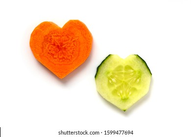 Carrot And Cucumber. 2 Slices In Heart Shape Isolated On White Background. Couple Relationship Concept. Difference Versus Similarity Concept. 