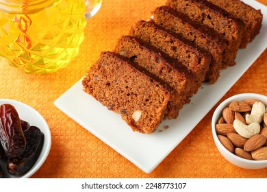 Carrot and dates cake made with dried fruit raisins cashew nuts and almond. Tasty home made flavored cinnamon Christmas new year cake in Kerala India Sri Lanka. Sweet dessert food.