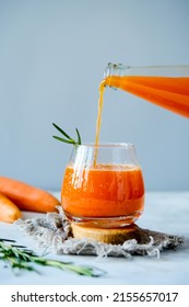 Carrot juice in a glassy glass. Freshly lived carrot juice. Orange carrot juice.