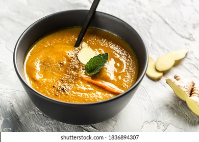 Carrot And Pumpkin Cream Soup With Baked Peppers And Cheese, Lime Juice And Ginger On A Light Background, Top View.