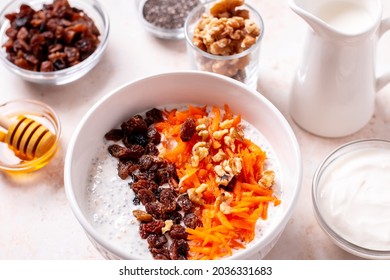 Carrot And Raisins Overnight Oats With Walnuts, High Protein Healthy Breakfast Or Snack On Table With Ingredients, Top View