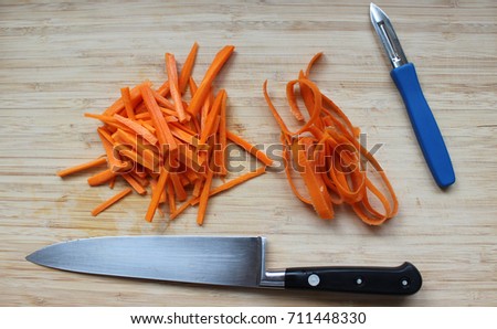 carrot slices on a wooden board with knive