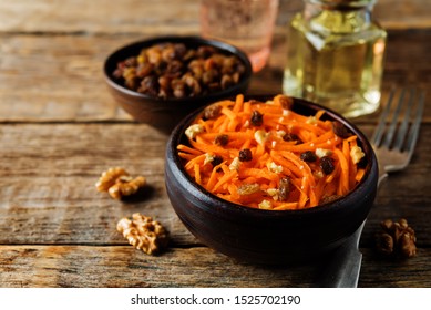 Carrot Walnut Raisin Salad With Glass Of Water. Toning. Selective Focus