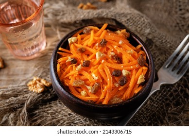 Carrot Walnut Raisin Salad With Glass Of Water. Toning. Selective Focus