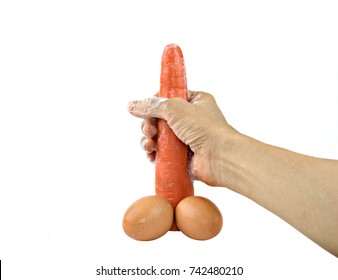 Carrots and eggs petting caress man penis erection satisfaction pleasure sex man hand masturbation concept isolated on white background.