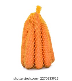 Carrots in a packaging mesh bag isolated on white background