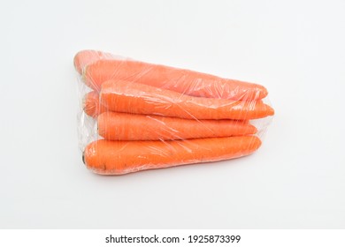 Carrots in plastic bag isolated on white background - Shutterstock ID 1925873399