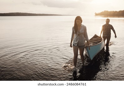 Carry, boat and couple by lake for adventure, rowing and sunset or journey in nature. Man, woman and sunshine or happiness for travel, freedom and support or canoe for wellness by river or creek - Powered by Shutterstock