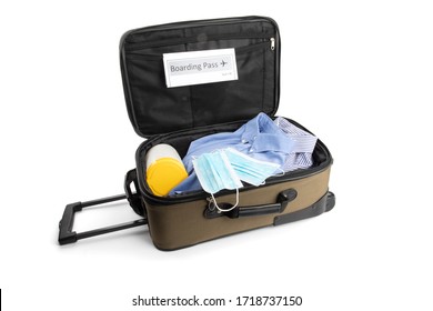 A Carry On Suitcase With A Generic Boarding Pass, A Surgical Mask And Disinfecting Wipes Suggesting The New Normal For Air Travel After Covid-19 Coronavirus