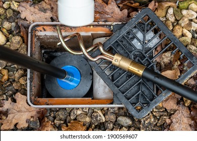 Carrying out emergency cleaning of a blocked drainage gulley outlet with a Drain rod with plunger attachment