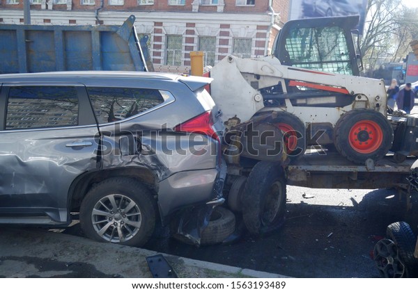 cars after a big road\
accident, rumpled car trim and bumper, closeup, accident on the\
road in the city