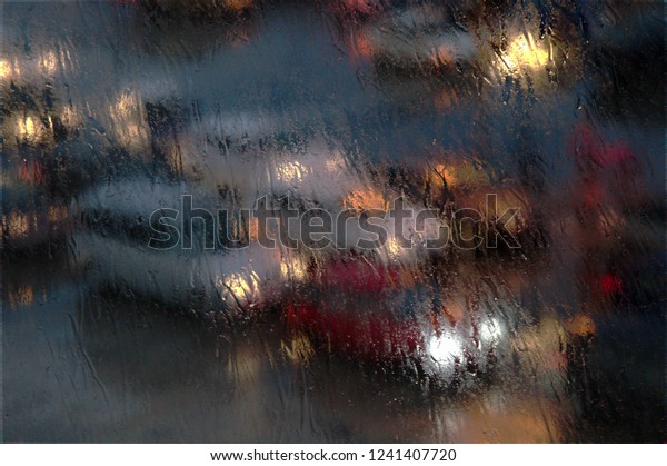 Cars behind blurring glass, raining,\
from the top of a ship at port,cars ready to enter\
ferry