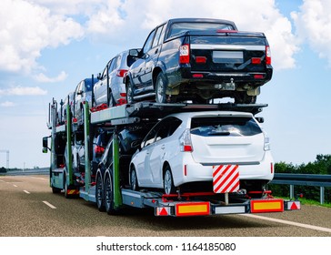 Cars carrier at the road of Poland. Truck transporter