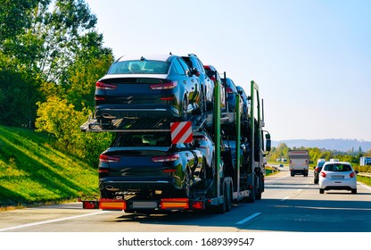 Cars carrier truck at the asphalt road, Poland. Truck transporter