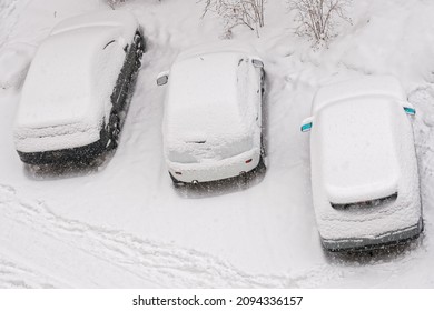 Cars covered by snow with their license plates removed are parked in the impoundment parking lot in winter. Snowfall. The concept of retribution for traffic violations. Winter car. Daylight