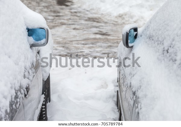 Cars covered with fresh\
snow