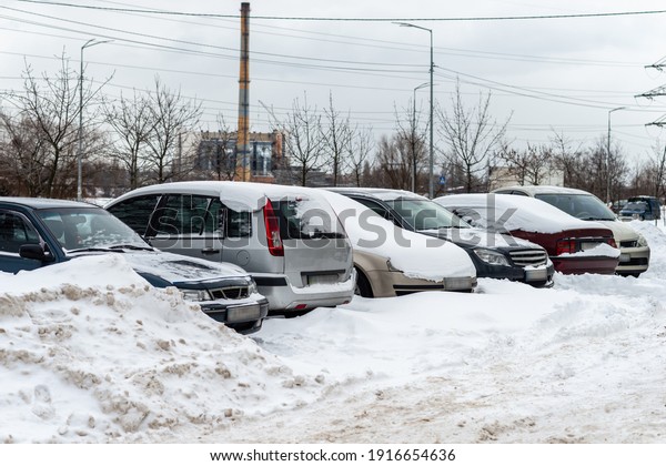 Cars covered with snow in\
the yard