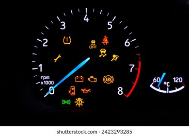 A car's dashboard lights up with multiple alert icons, signaling various vehicle functions and warnings in a clear, colorful display. - Powered by Shutterstock