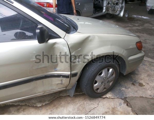 Car\'s dent\
beside right wheel from an\
accident.