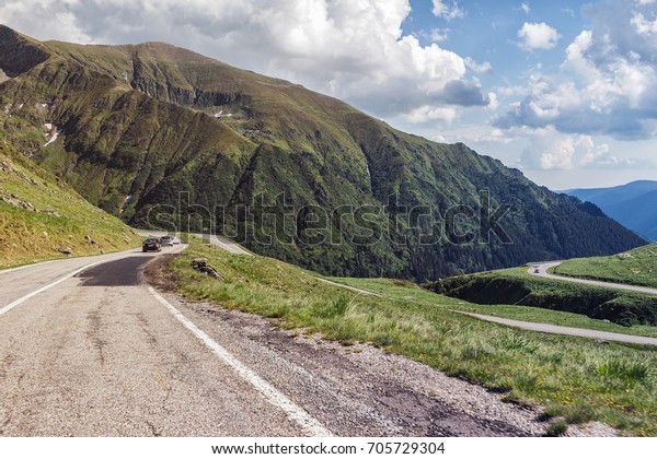 Cars drive on the most famous and dangerous road\
in Europe is a Transfagarasan road in Carpathian mountains,\
Romania.