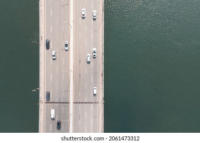 Cars Drive On The Road Bridge Over The River Top View.