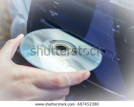 Car's driver insert CD in to CD player
