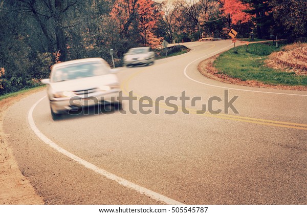 Cars\
driving around the curve, motion blur on\
cars
