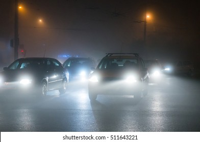 Cars Driving In The Fog At Night. 