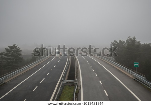 Cars driving in heavy\
fog