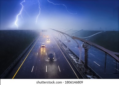 Cars Driving On A Highway In A Pouring Rain With A Thunderstorm. Storm, Lightning And Fog Over Dark Road