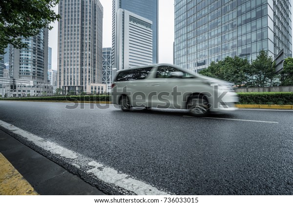 cars\
driving on inner city road of shanghai,\
china.