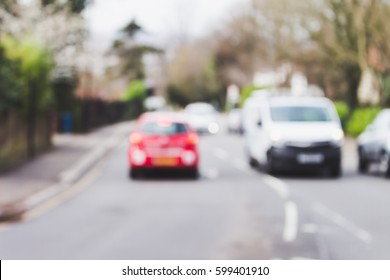 Cars Driving On The Road, On The Left Hand Side, London, UK, Blurred, Red Car, White Van Abstract Background.