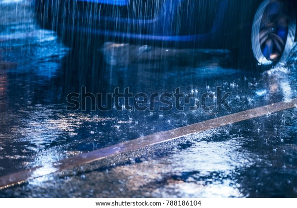 Cars\
driving on wet road in the rain with\
headlights