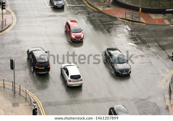 Cars driving\
in poor road and weather\
conditions