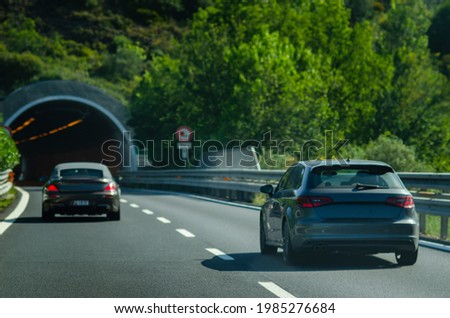 The cars entering the road tunnel on an Italian highway 