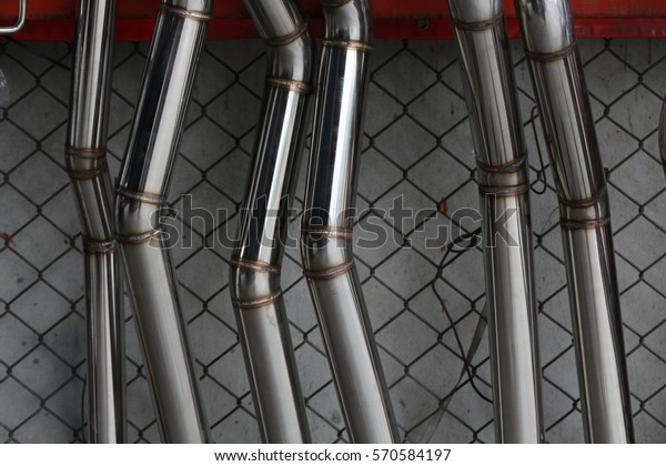 Car\'s exhaust system in\
exhaust shop