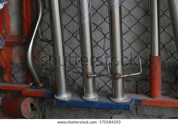 Car\'s exhaust system in\
exhaust shop