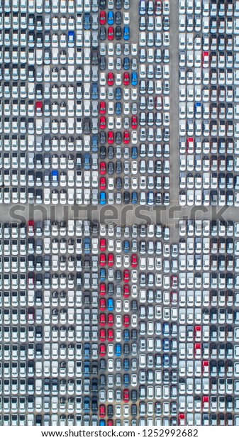Cars export terminal in export and\
import business and logistics. Shipping cargo to harbor. Water\
transport International. Aerial view and top\
view.