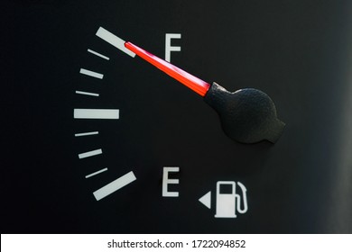 The car's fuel gauge shows a full, close-up, rough black panel. - Powered by Shutterstock