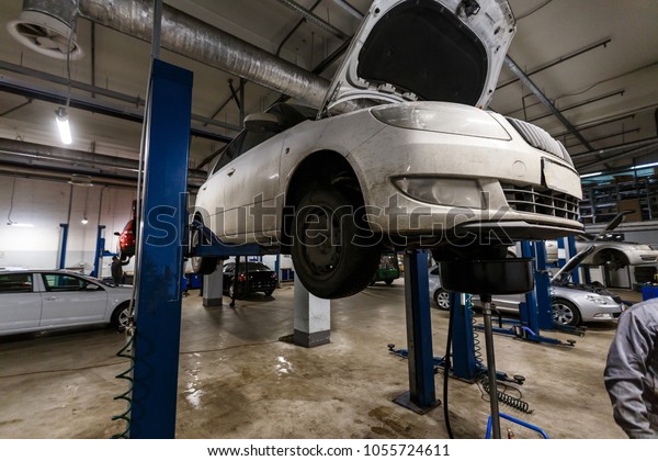 cars\
in garage with special equipment prepared for\
repair