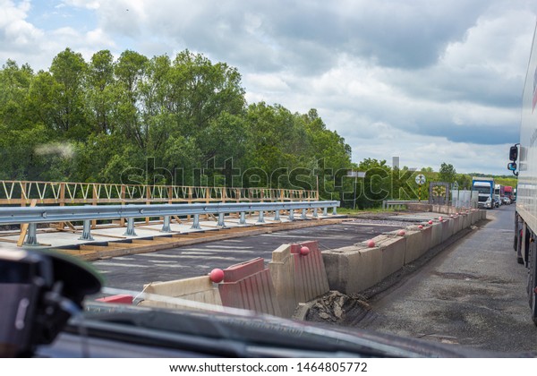 cars go along the right lane of\
the road, the left lane is being repaired, it is perekrat, cars are\
visible in the distance, waiting for permission to\
move