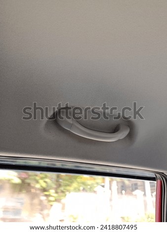 Car`s grab handle ,Holding plastic car grab handler for the passenger.
travelling ,  car grab handle