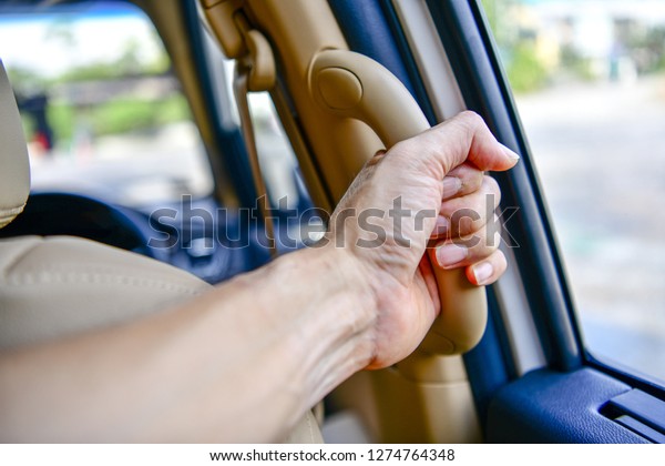 Car`s grab handle,Holding plastic car grab\
handler for the\
passenger.