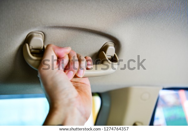 Car`s grab handle,Holding plastic car grab\
handler for the\
passenger.
