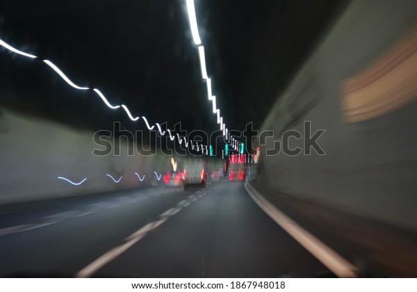 Cars\
inside a highway tunnel. Color light trails\
effect.